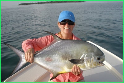 charter customer holding a permit fish